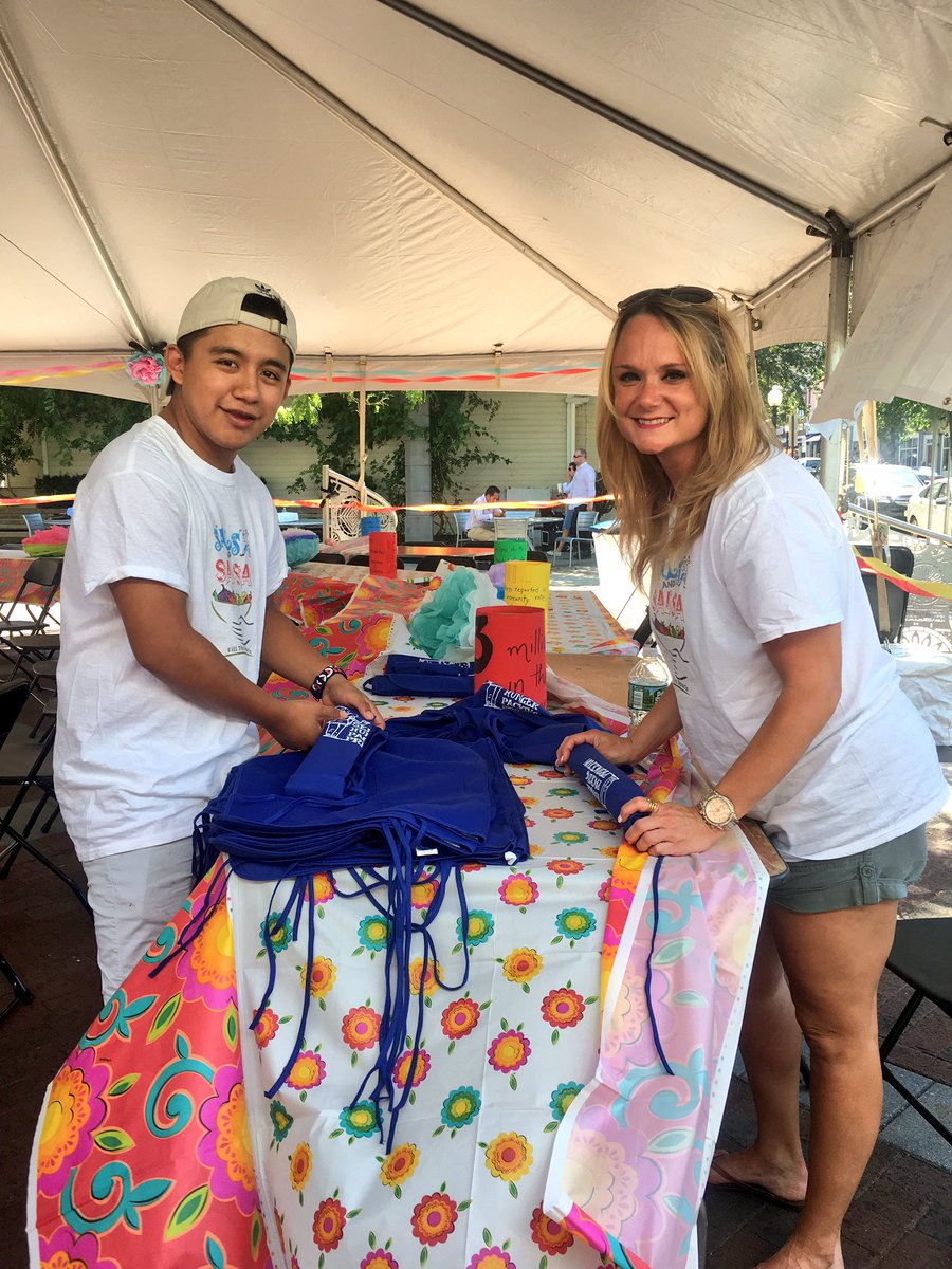 Our great volunteers at work getting SHUPP aprons ready for #salsaandsalsa thanks, Luis and Leah!