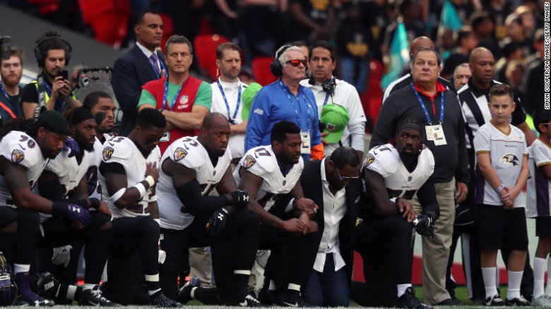 CNN's tweet image. Kneeling. Locked arms. Raised fists. Today, NFL players showed unity in defiance of Trump cnn.it/2y1lAOa