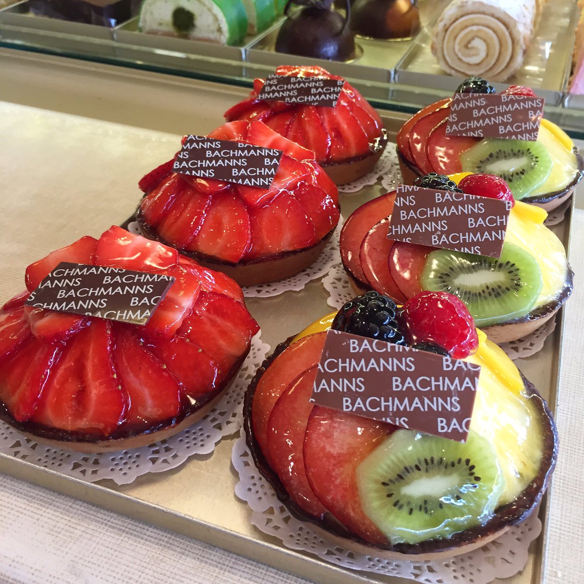 Our Mixed Fruit Tarts. Pastry case brushed with chocolate, filled with Grand Marnier diplomat filling, topped with fruits and glazed! 🍓🍍🥝