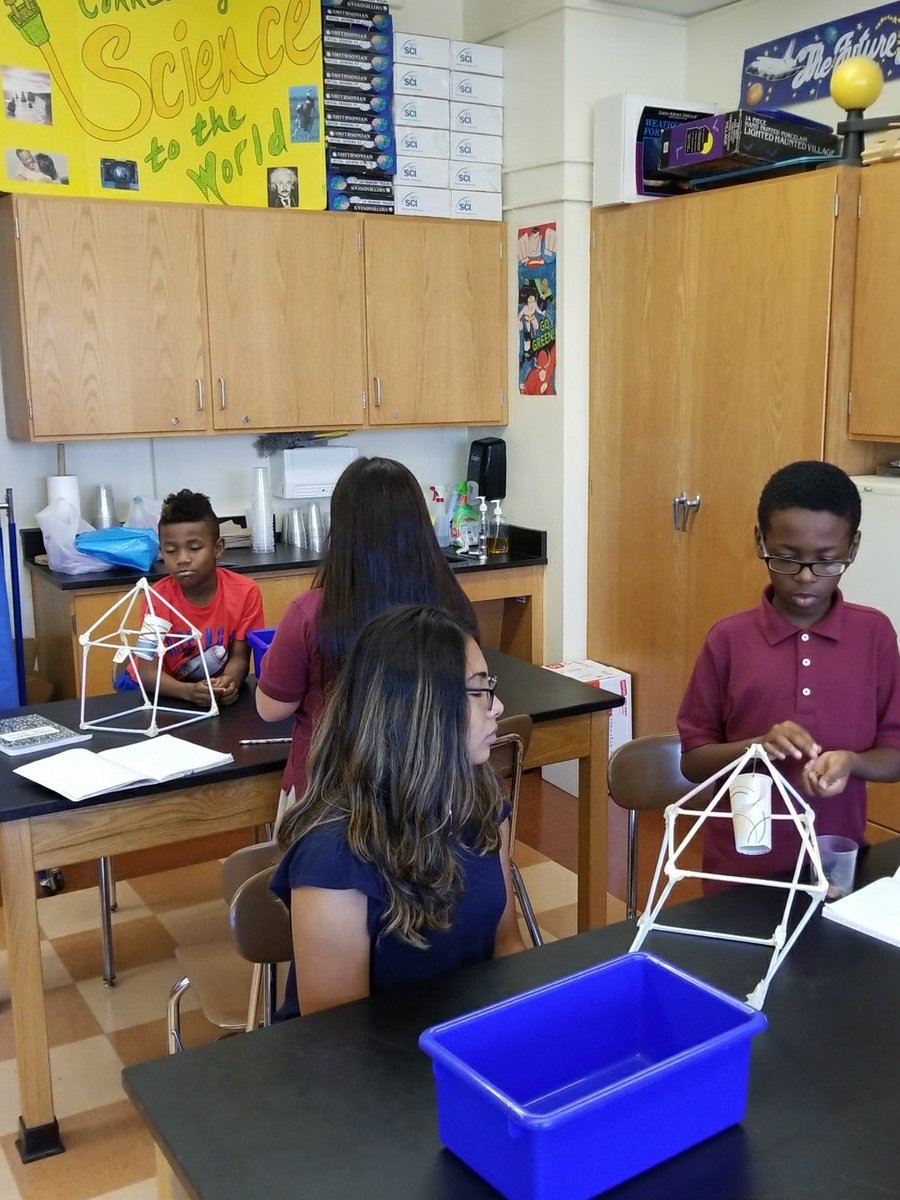 4-300 testing their straw models for strength and stability.