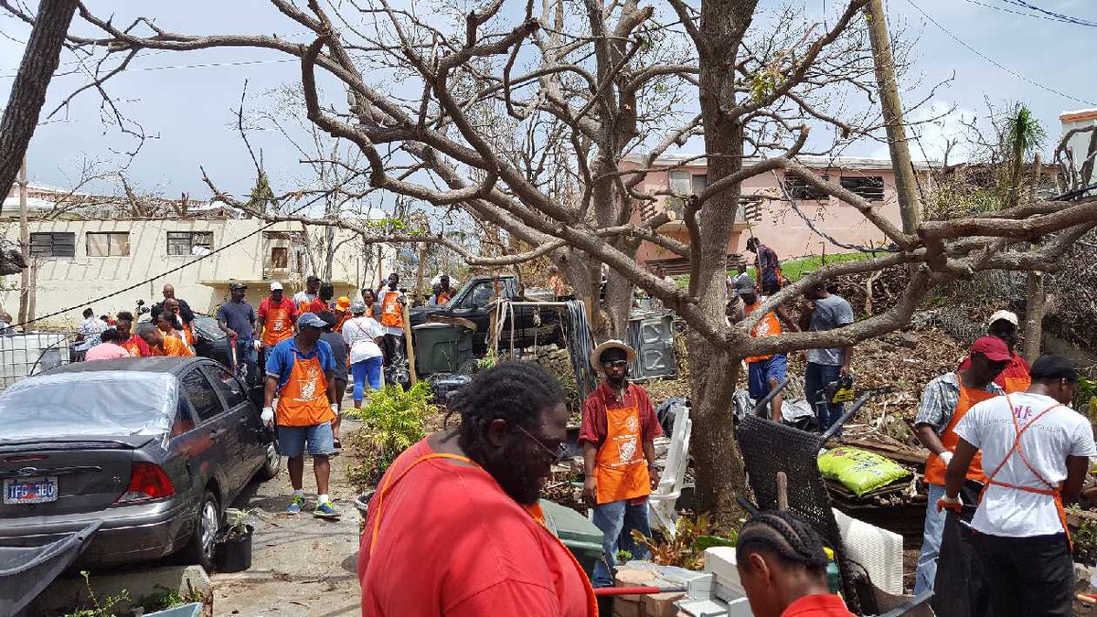 HD6872's tweet photo. A sea of orange! St.Thomas associates can't work in their store so they're working in the community helping out neighbors clean up. Amazing! https://t.co/MiS2C1wPpK
