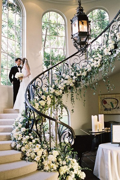 #WeddingWednesday 💍
Floral Wrapped Staircase
Bountiful blooms trailing the banner of a winding staircase bring fresh, classic vibes.