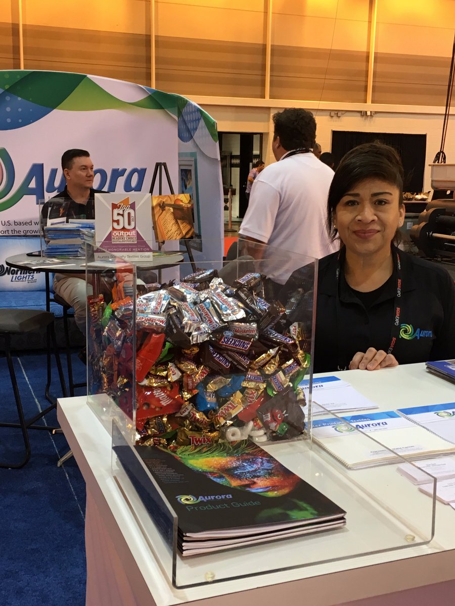 Aurora_Textiles's tweet photo. It's that time of day! Stop by the Aurora booth 1059 at SGIA Expo for a chocolate bar break! #SGIAExpo #PRINTING https://t.co/k7mhRyXvTM