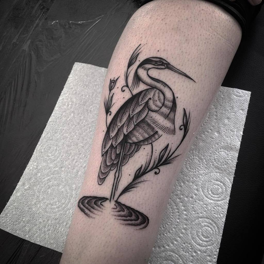 Heron tattoo on the upper arm