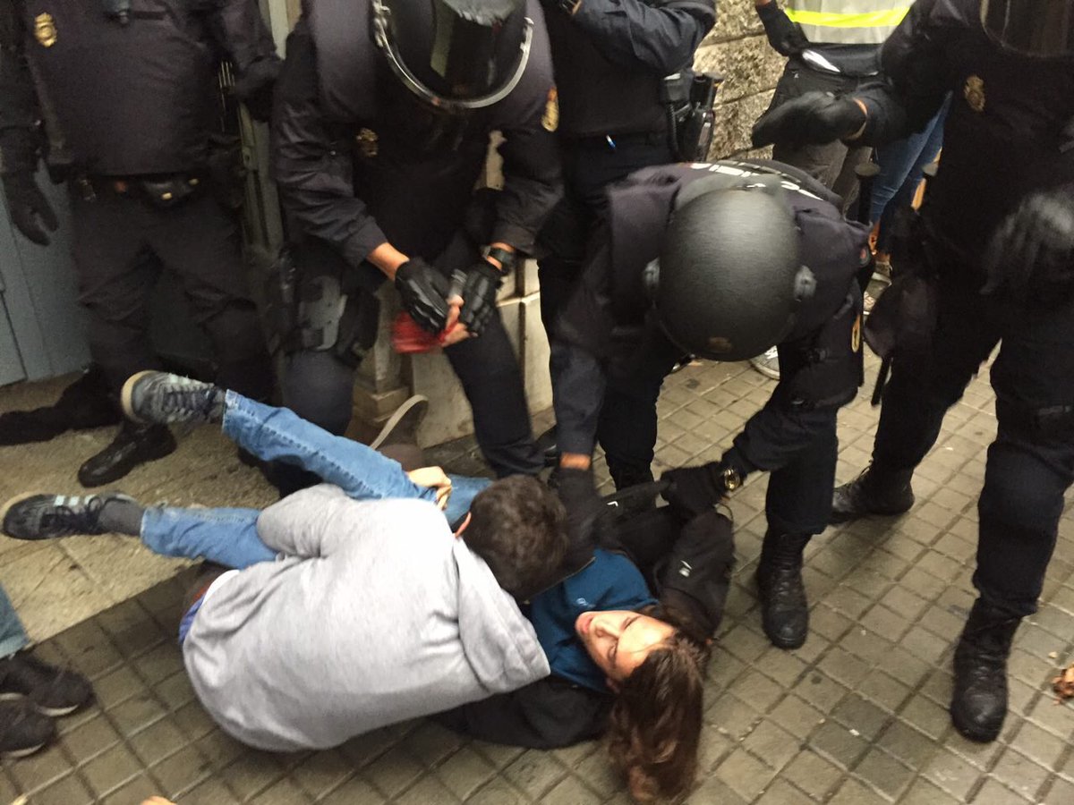 catalangate's tweet photo. ❗️Spanish police raiding over peaceful people at a polling station in Barcelona. Please spread the news! #catalanreferendum https://t.co/OQXBjRb3tZ