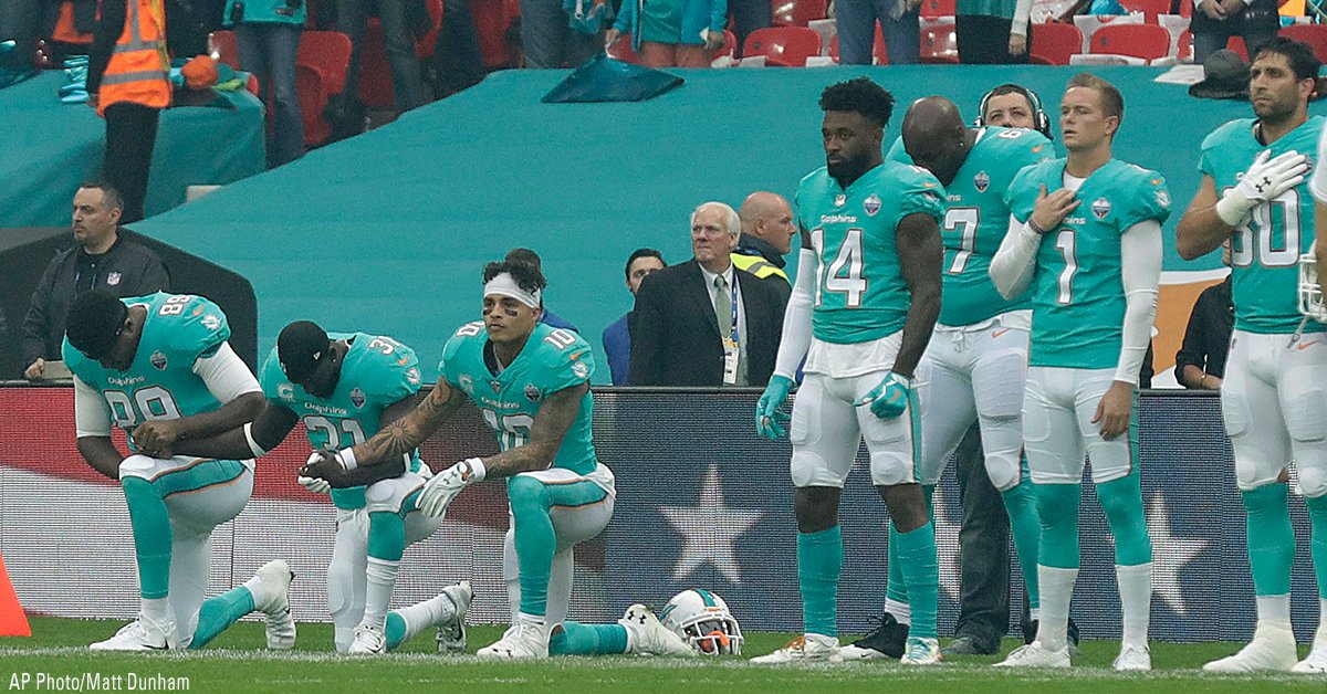 FoxNews's tweet photo. Three members of the @MiamiDolphins took a knee as the U.S. national anthem was played before an NFL football game in London, England. https://t.co/QGNKtLDgcd