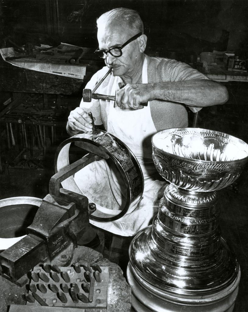 keeperofthecup's tweet photo. Engraving the #stanleycup. Not much has changed in the last century.  Same trophy, same tools, new names. @NHL @penguins  @HockeyHallFame https://t.co/JGifOPhkWH