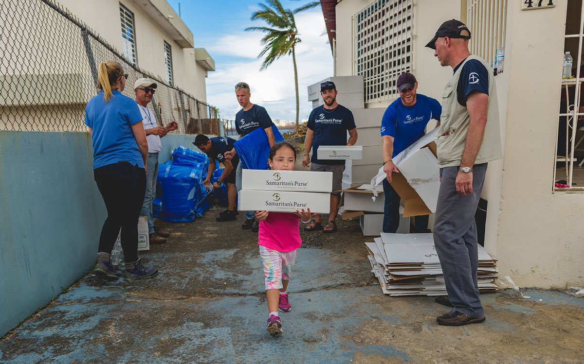 SamaritansPurse's tweet photo. A young samaritan helps our disaster response team distribute emergency supplies to families in #PuertoRico. https://t.co/1BMuW1yzzF https://t.co/c6O5Wngswm