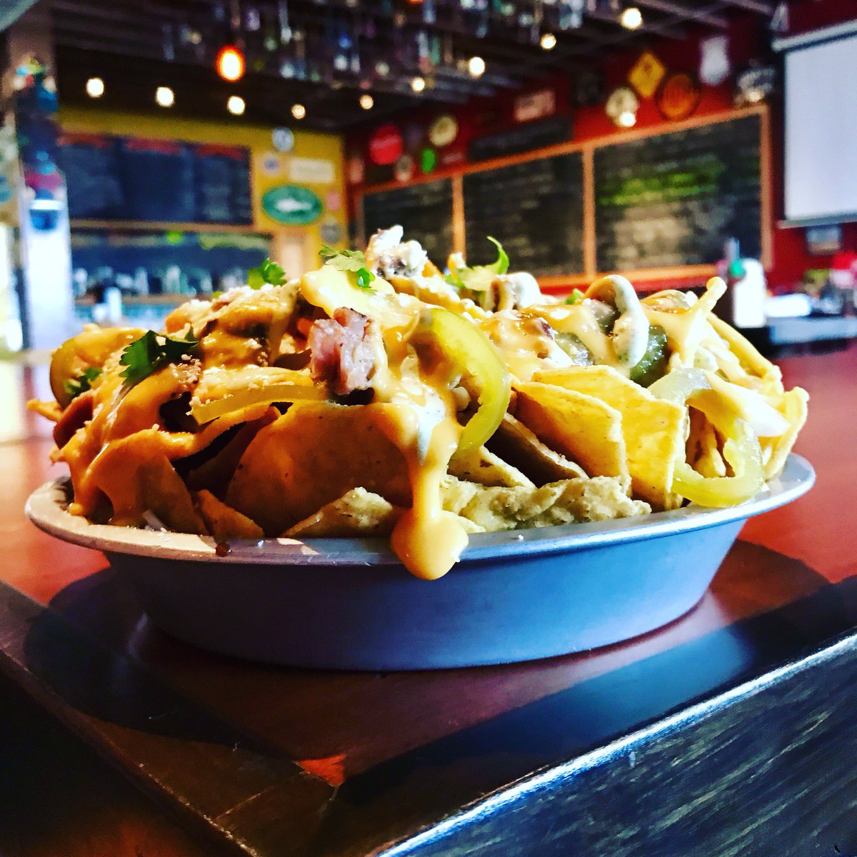 TRHkitchen's tweet photo. Nachos Verde Monday @theredhot today and every Monday! Tortilla chips, Smoked Pork, Onions, Salsa Verde, Cotija, Pepperjack, Nacho Cheese, Jalapeños, Lime-Cilantro Crema #Tacoma #Craftbeer #Nachos #Caseofthemonday https://t.co/bwYEIPsg9b