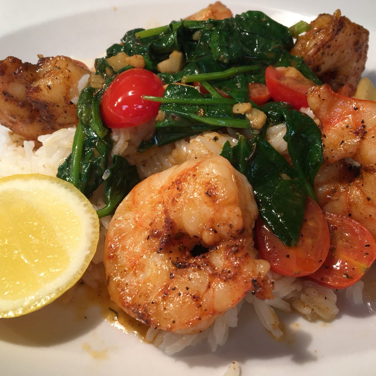Blackened shrimp scampi over rice w/spinach &amp; tomatoes.