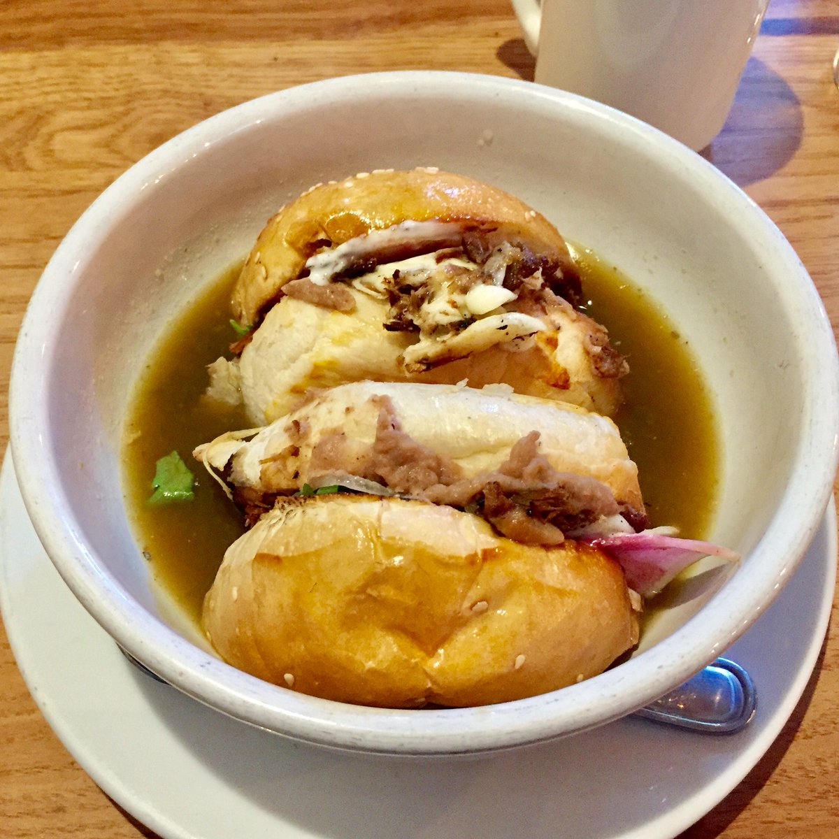 MarabuntaTX's tweet photo. Cemita Ahogada, Wild Boar, Radish, Onion, Refried Pintos, Cilantro, Queso Oaxaca on a Cemita Roll in a Spicy Broth @DaiDue #brunch #atx https://t.co/aG3ilfwNc1