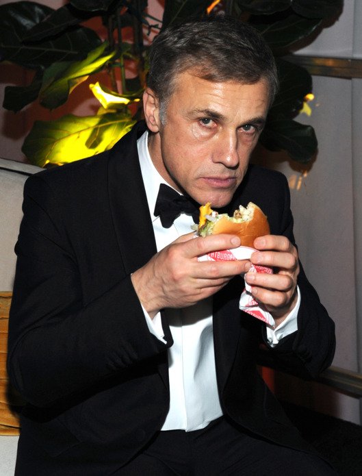 Happy birthday, Christoph Waltz! Here\s an iconic image of him eating a burger at a 2015 Golden Globes afterparty 