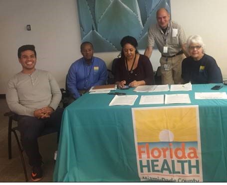 HealthyFla's tweet photo. #FLHealth in #Miami provide assistance at #FLDisaster Center at @iflyMIA to Puerto Rican families displaced by Hurricane #Maria. https://t.co/000zUR10Ye