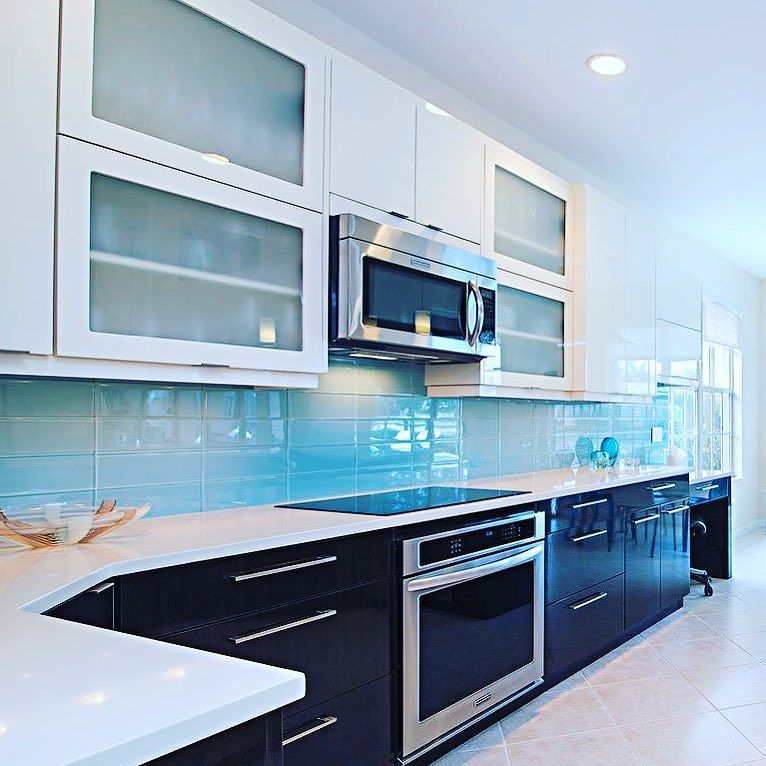 Our Lush 4x12 Vapor pale blue glass subway tile gives subtle color to this cool kitchen. #weloveourclients All in st…