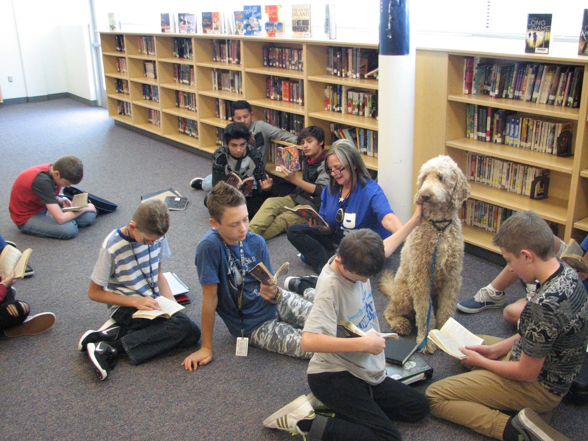 WSDLibraries's tweet photo. Mrs. Irvine, her reading class, and Bentley the reading dog are enjoying a good story at South Junior High.  #weberlibraries https://t.co/y4e5pCYmo2