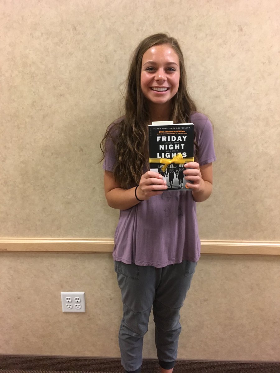 WasatchReads's tweet image. Brittany Burton finds a book on the wooden W at the football stadium.