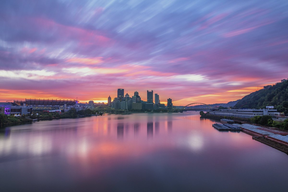 The skies over #Pittsburgh were once again incredible this morning, as purple &amp; pink clouds streaked by the city and reflected in the river