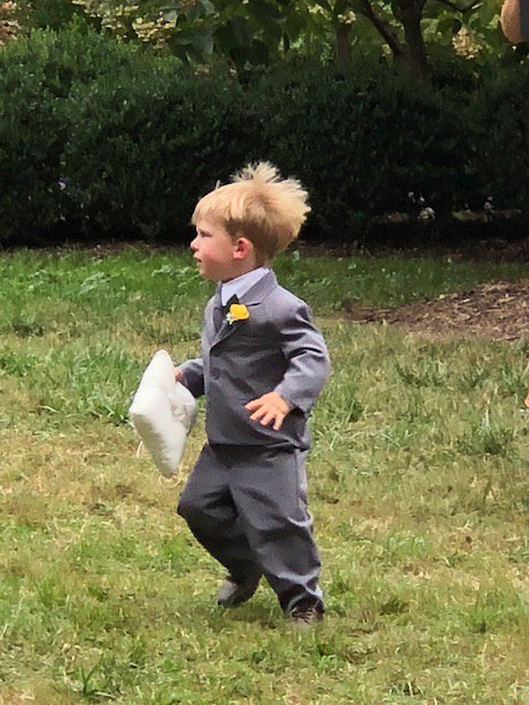 This litle boy was the ringbearer at a wedding yesterday.  As he approached the couple at the altar, he turned and fled, with the rings.