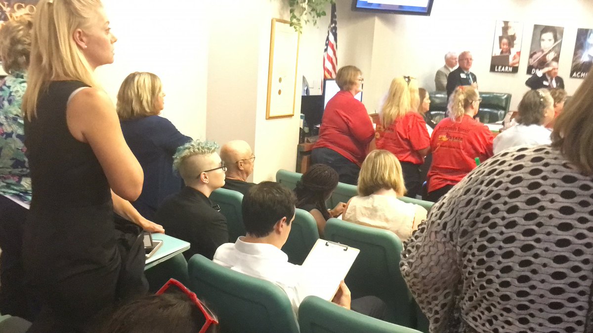 A group of people remained seated during the Pledge of Allegiance at the Manatee school board meeting Tuesday.