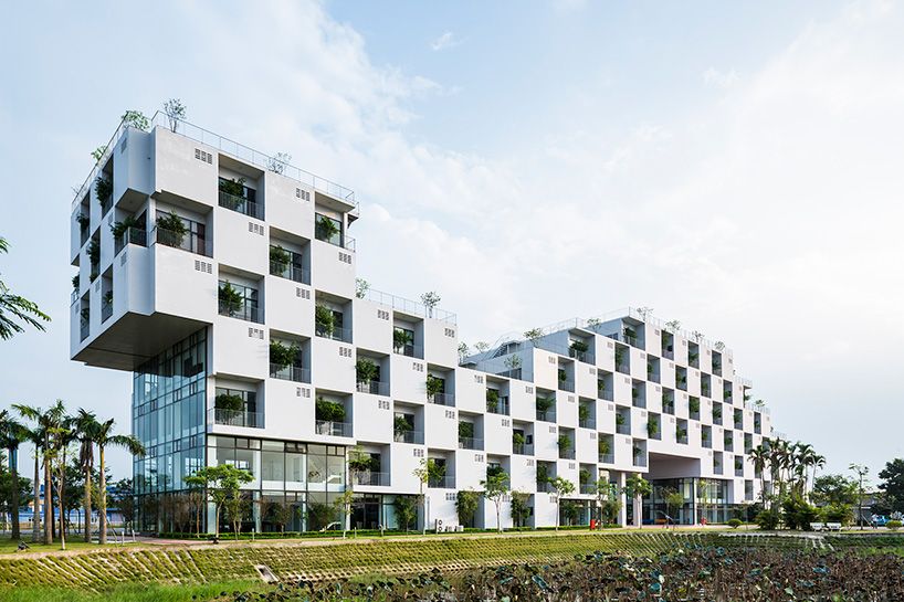 designboom's tweet photo. checkerboard façade of VTN's hanoi university building contains trees within recessed voids https://t.co/QLsKIju7mP https://t.co/THk7Bbh0UY