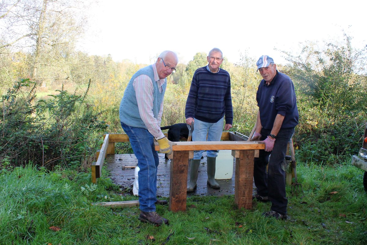 Rotarians busy improving our local environment adding a bench to the new viewing platform on Mariott's Way.
