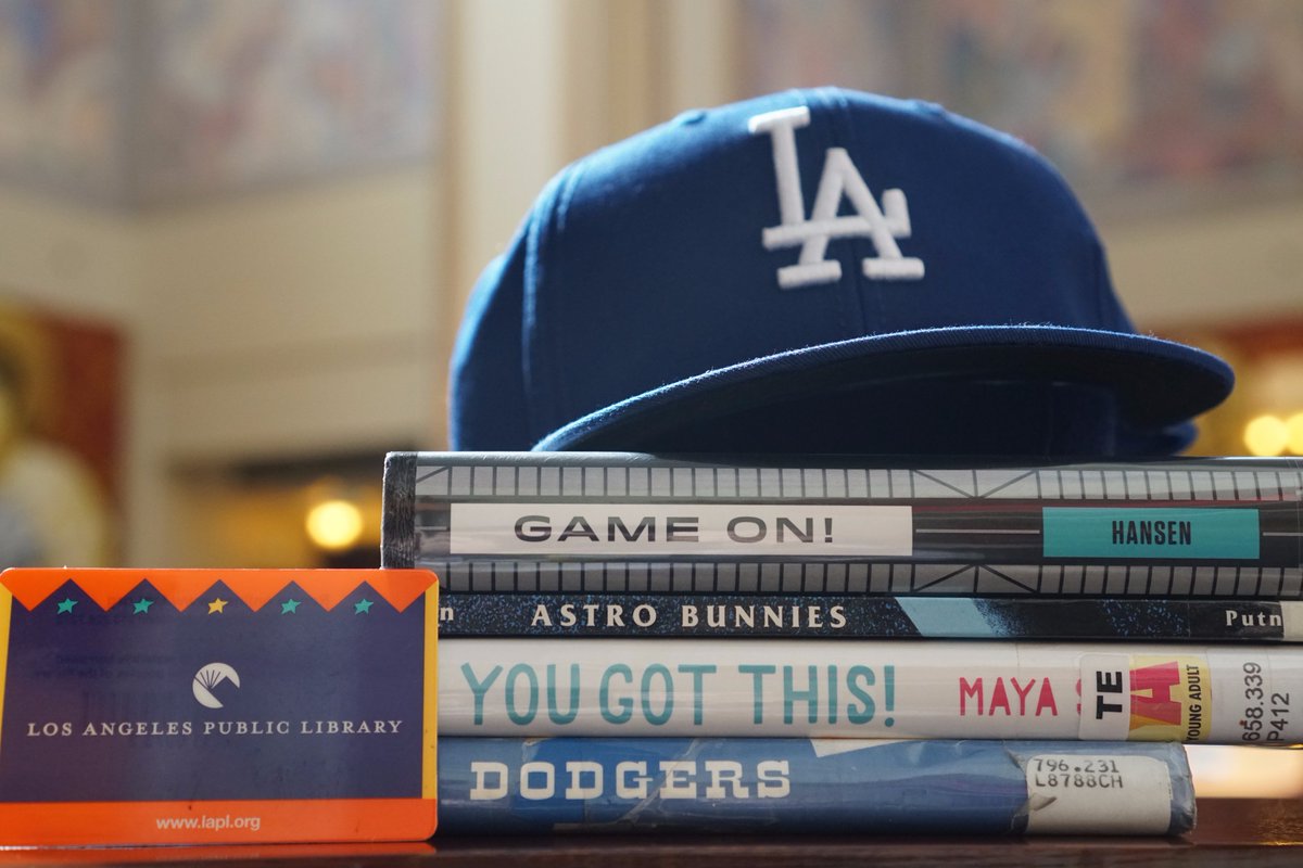 Book spine poetry with Dodger hat and library card