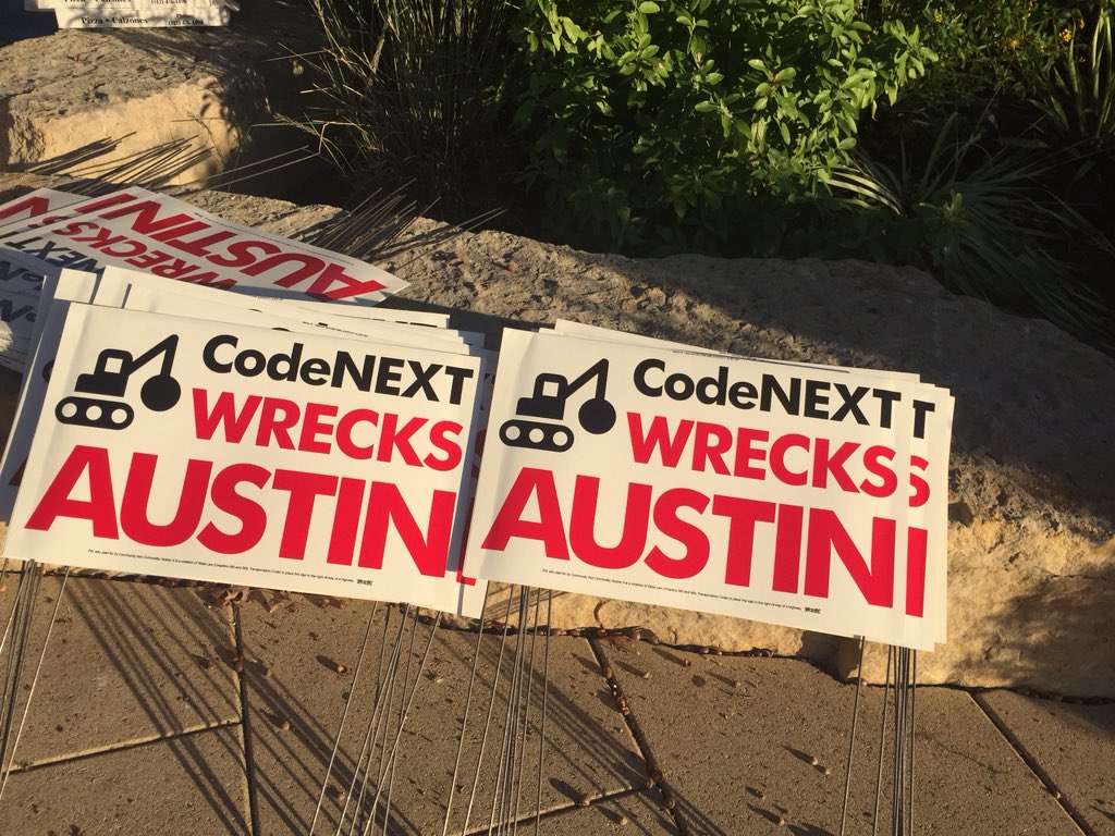 PhilJankowski's tweet photo. Signs from Community Not Commodity being handed out #CodeNext https://t.co/vdAYnVsUzw