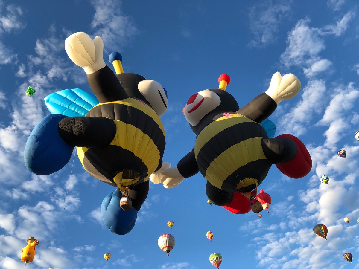 Holding hands... the #balloon bees make their way over the field for day 7 of #BalloonFiesta They’re always a crowd favorite. #krqe