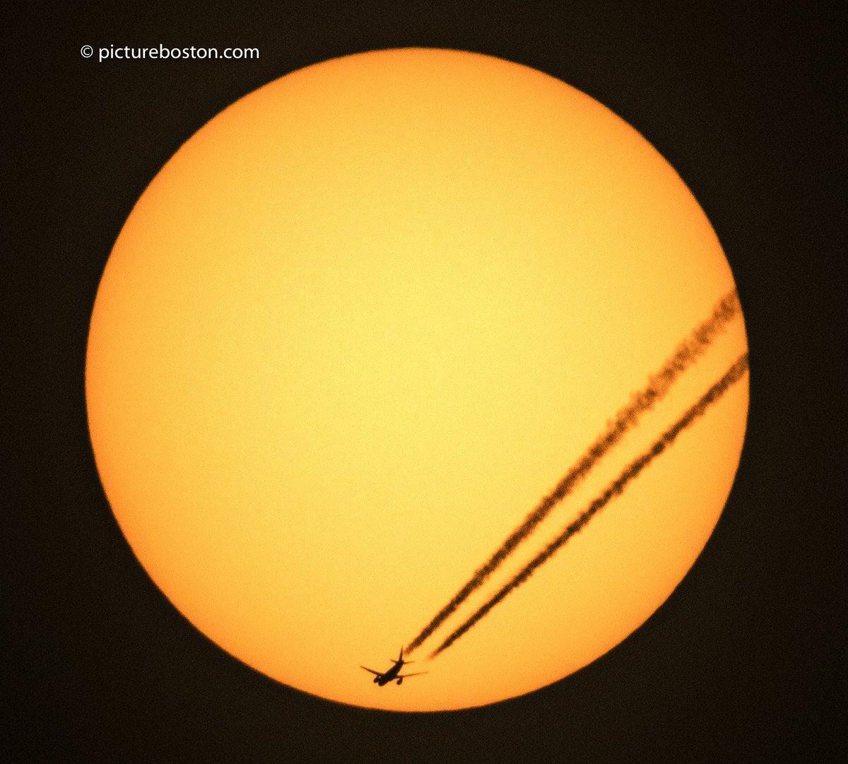 pictureboston's tweet photo. The #Boston sun a few min ago as @British_Airways @Airbus A318 crosses my view of it. Flight BA1, Shanon-@JFKairport @CanonUSApro #AvGeek https://t.co/ARg8On3eEz