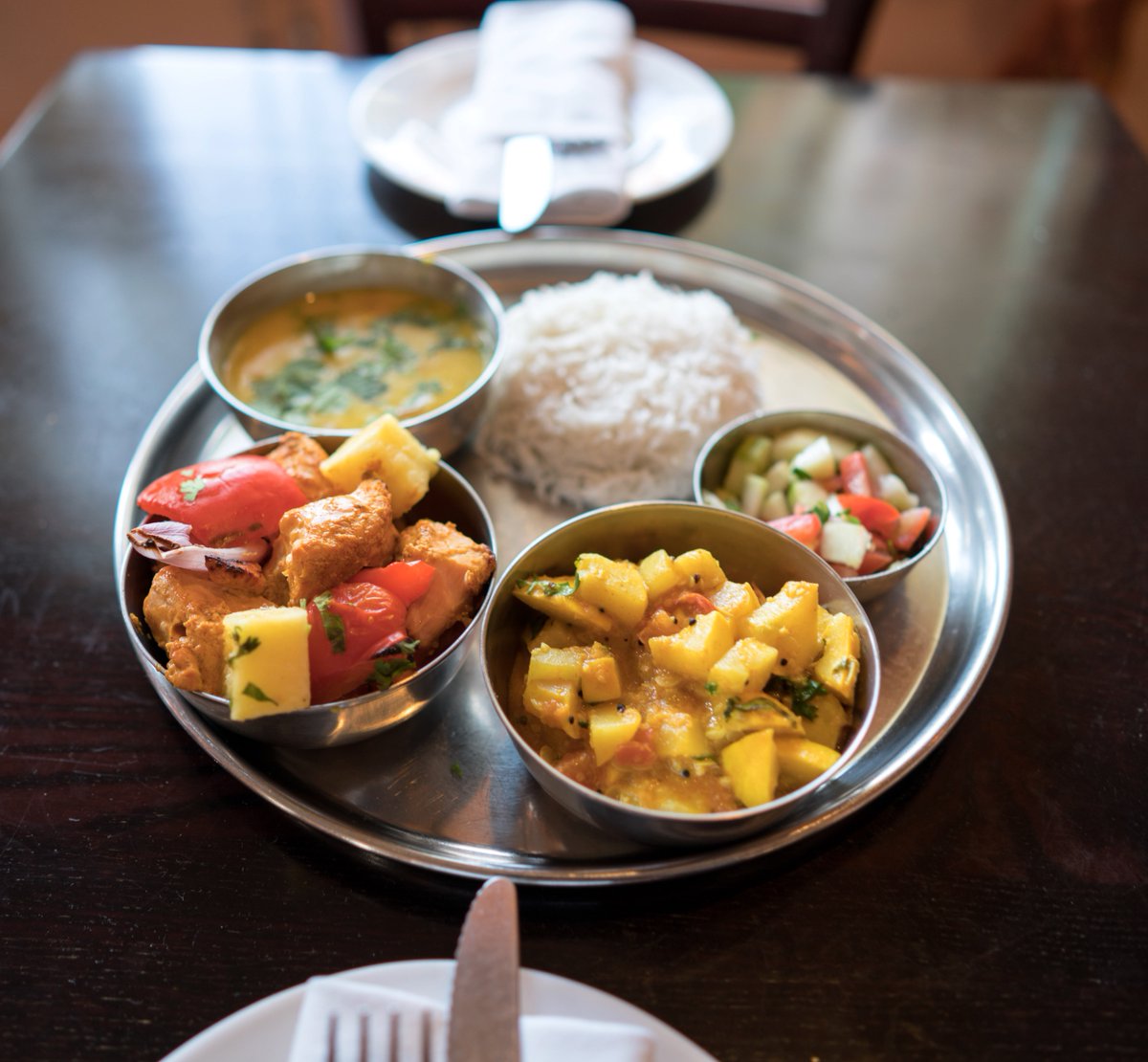 DhabaSM's tweet photo. Can't decide? Get the Thali! A traditional combo dinner with kachumbar, dal/ veggie of the day, rice &amp; your choice of entrée. #FridayDinner https://t.co/QI3HIWHKsq