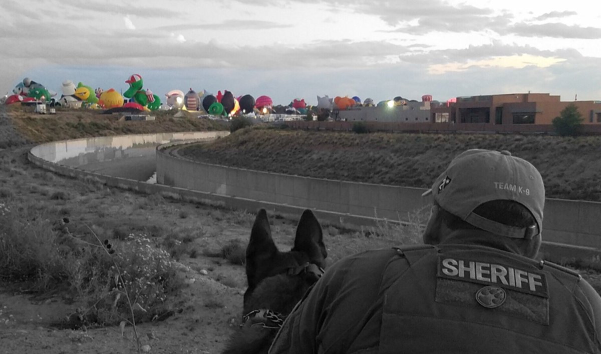 BCSONM's tweet photo. Deputy Martinez and K9 Vito enjoying a beautiful fall morning and watching hot air balloons take flight! #K9Unit #Malinous #DogsWithJobs https://t.co/dwJ77f2QEe