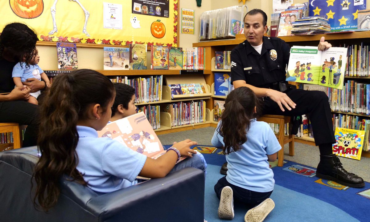 Police officer reading to children