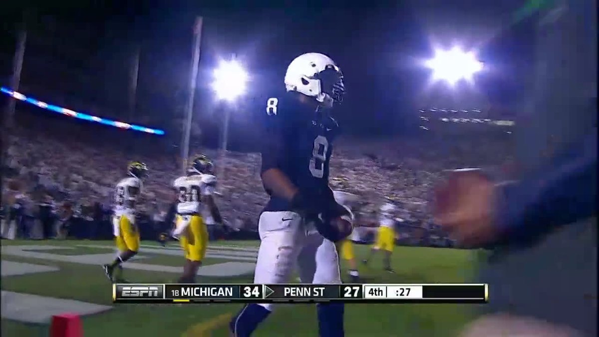 A broadcast screenshot from ESPN shows a Penn State football player, wearing number 8, holding the ball during a game against Michigan, with the scoreboard reading Michigan 34, Penn State 27, in the 4th quarter with :27 on the clock.