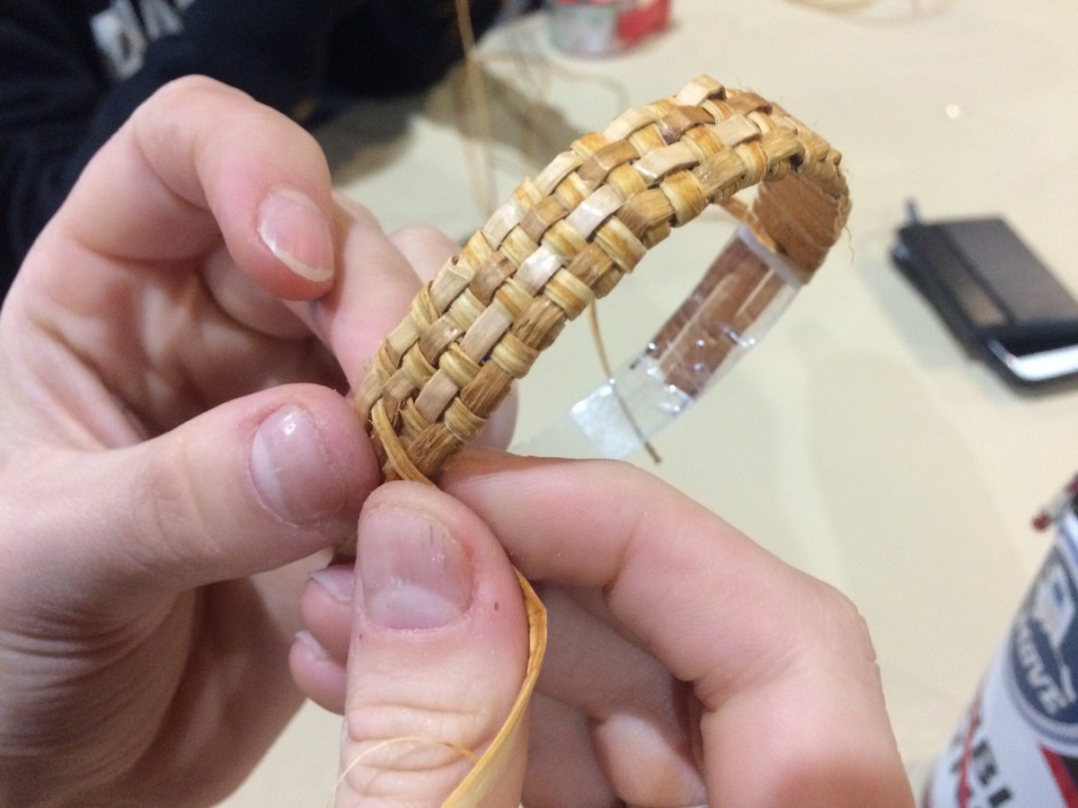 HeatherHintze's tweet photo. Elder Della Cheney shows kids how to weave cedar bark bracelets. It's a unique skill she learned from her grandma in Southeast. #EY2017 https://t.co/9nsXif28BV