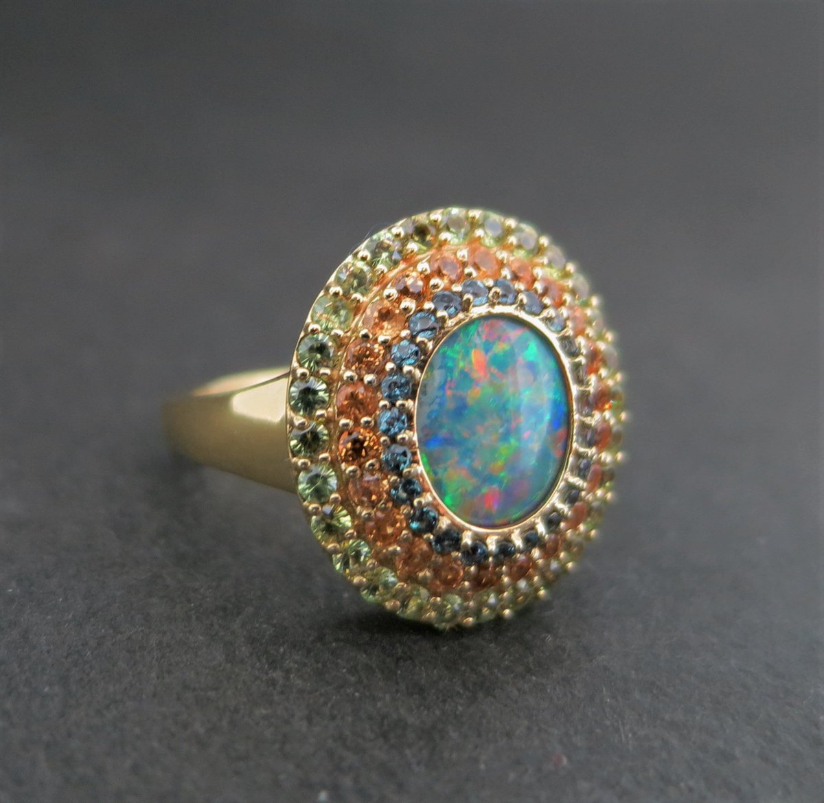 llynstrong's tweet photo. New #18k yellow #gold triple-halo #opal #ring with #spessertitegarnet, #dematoidgarnet and #alexandrites here to prove #color is nothing to be afraid of! #llynstrong #jewelry https://t.co/2Or8253exc