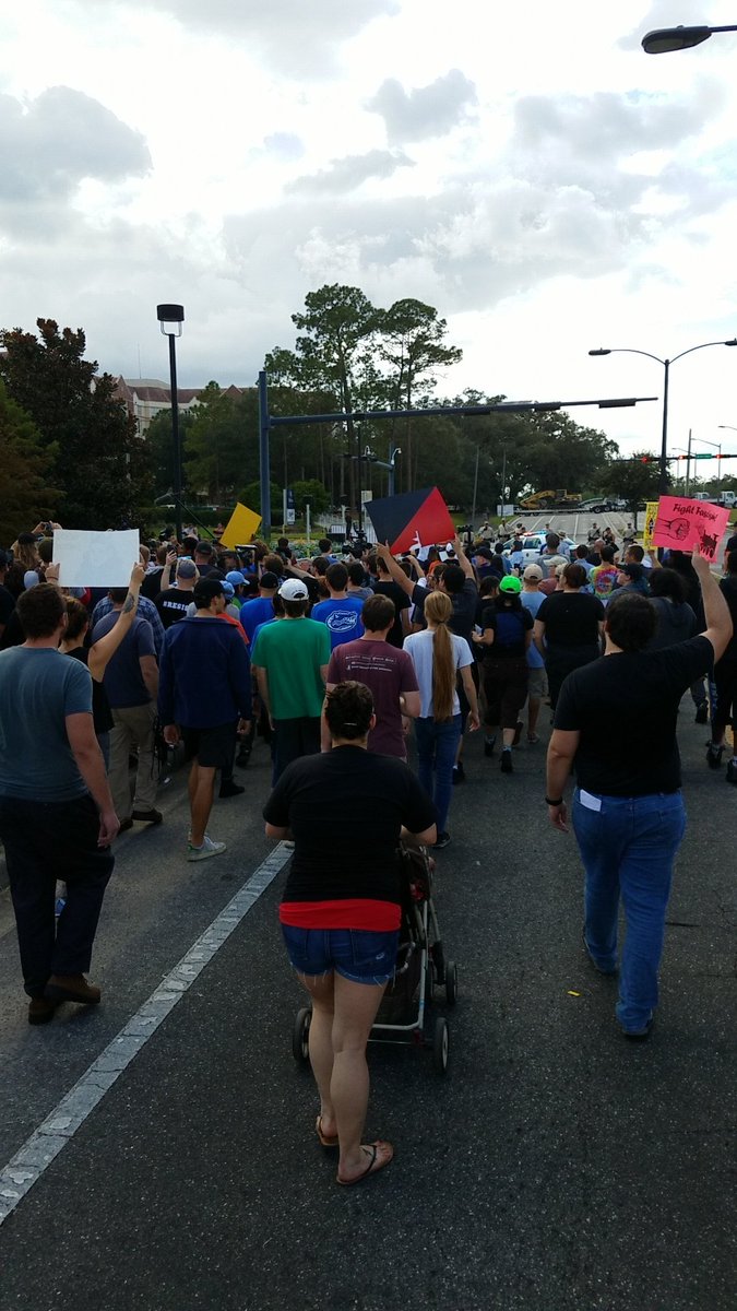BrandonLaines's tweet photo. Crowd is walking another Nazi out. #NoNazisatUF https://t.co/x3uHqHGThn