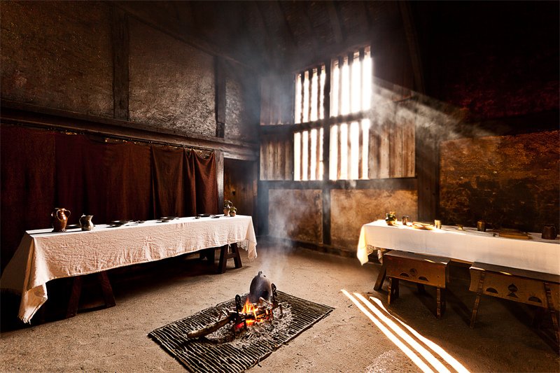 The open fire in the center of the room was perfect for thatched roof houses. The smoke would rise up and "cure" the roof, drying it out.