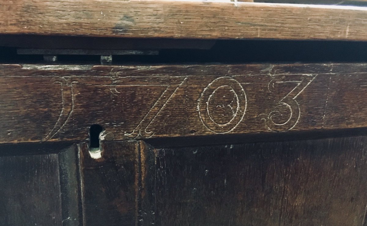 A dated oak chest with particularly characterful serifs..