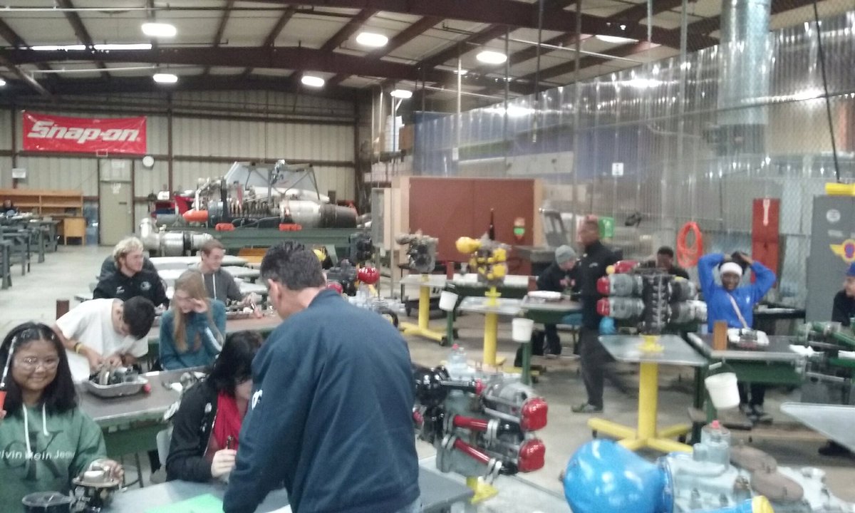 LHS taking apart jet carburetors at the Aviation Institute of Maintenance.