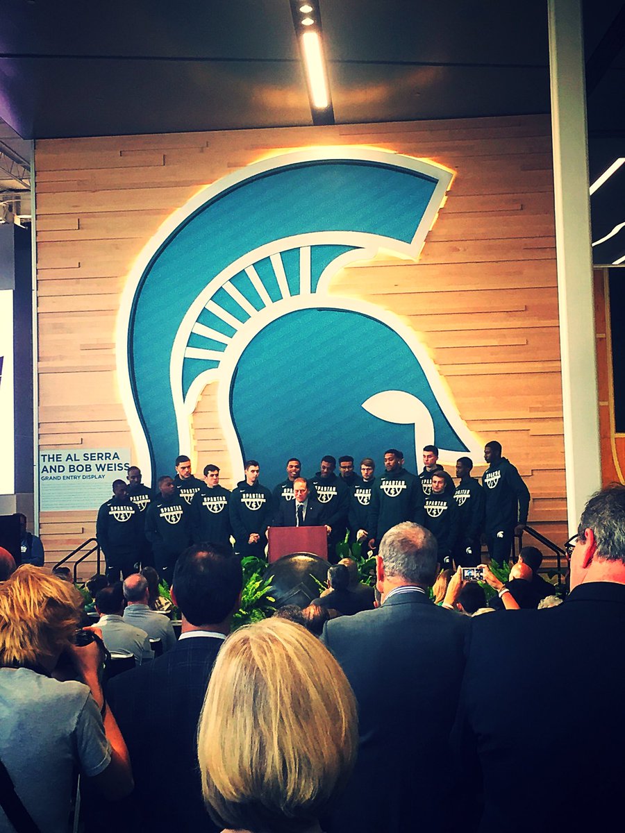 MSU_Basketball's tweet photo. “It’s not about me, it’s about us,” Head Coach Tom Izzo says w/team behind him at Hall of History opening. https://t.co/dd4i3DwbVv