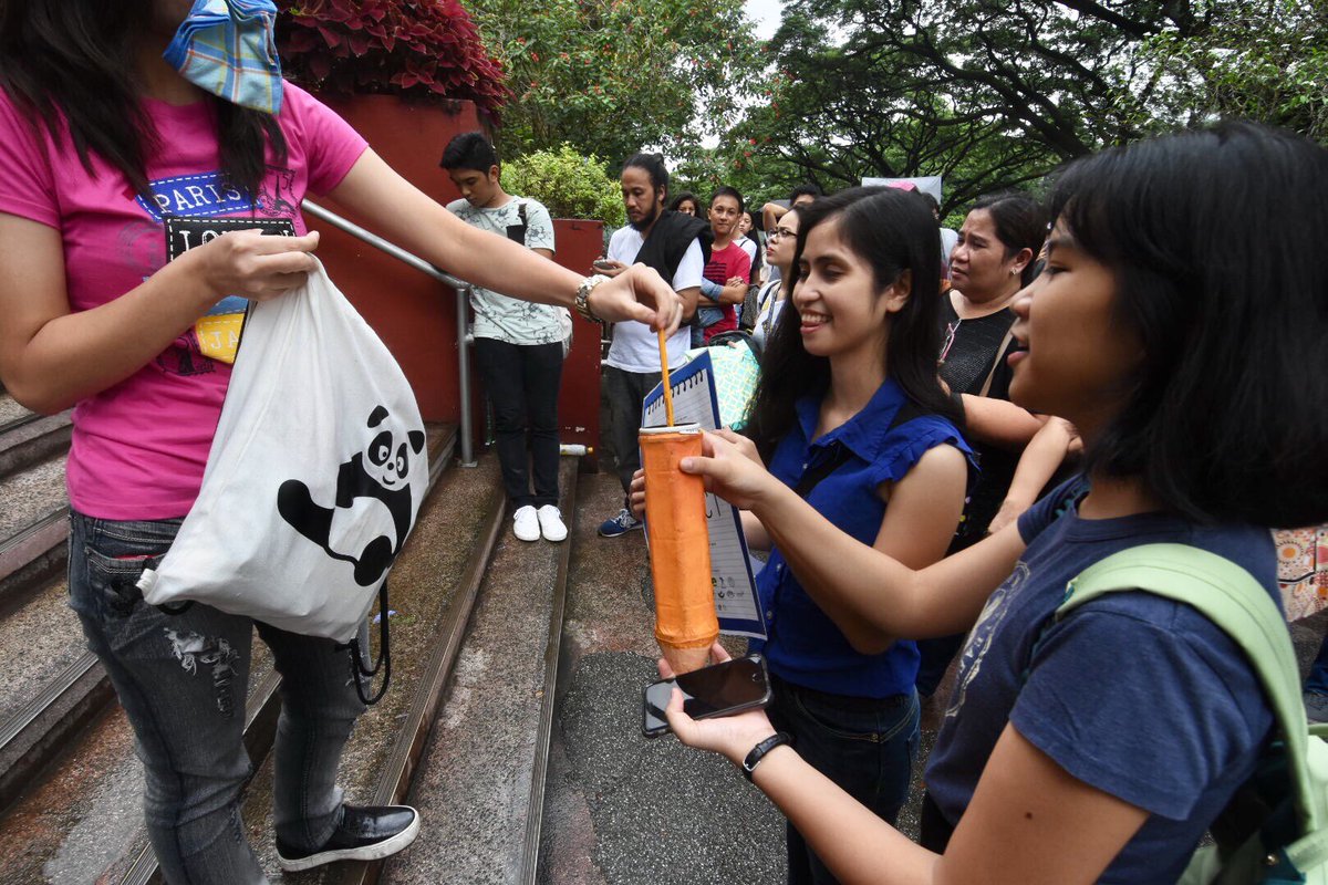 A group of students ask exminees of UPCAT to donate their pencils for the underprivilege.