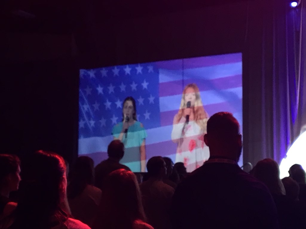 CTEwithAngie's tweet photo. #PLTWSUMMIT kicked off with beautiful rendition of American Anthem....all educators standing! Let the Summit begin!! 10-strong from #WestAda https://t.co/aqvf7ocAZB