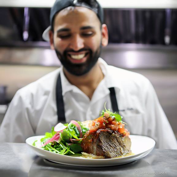 Exciting changes at Barrio! New #chef new #menu. Chef Roven is all smiles when it comes to the chili braised beef! #barrioonqueen