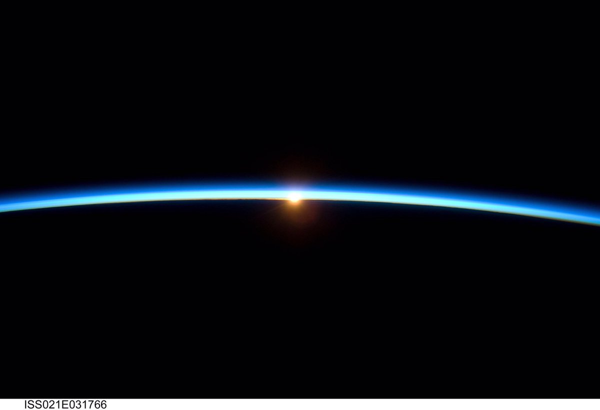 spaceboies's tweet image. A glimpse at the sun peeking through the thin layer of atmosphere hovering over the Earth.