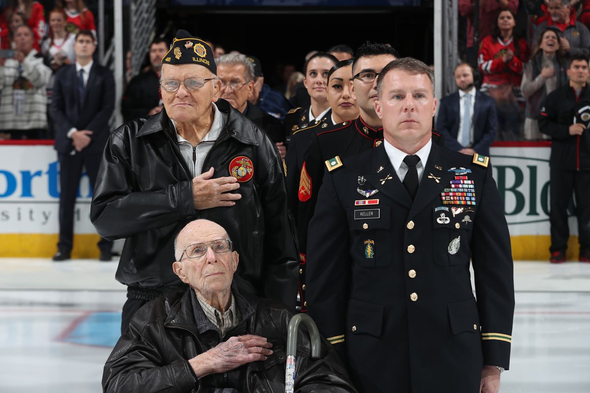 NHLBlackhawks's tweet photo. Some of the 60 members of the United States Armed Forces who were recognized during tonight's National Anthem. #VeteransDay https://t.co/0u6EoZ2a9H