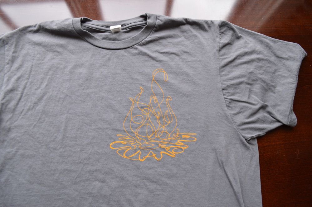 Discharge ink settles into the fabric, producing the softest shirt prints possible.