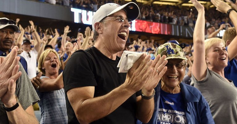 theScore's tweet photo. Diehard Mets fan Jerry Seinfeld caught at Game 1 cheering for Dodgers. https://t.co/AwZvYoWp7Q https://t.co/uI5tAmkUam