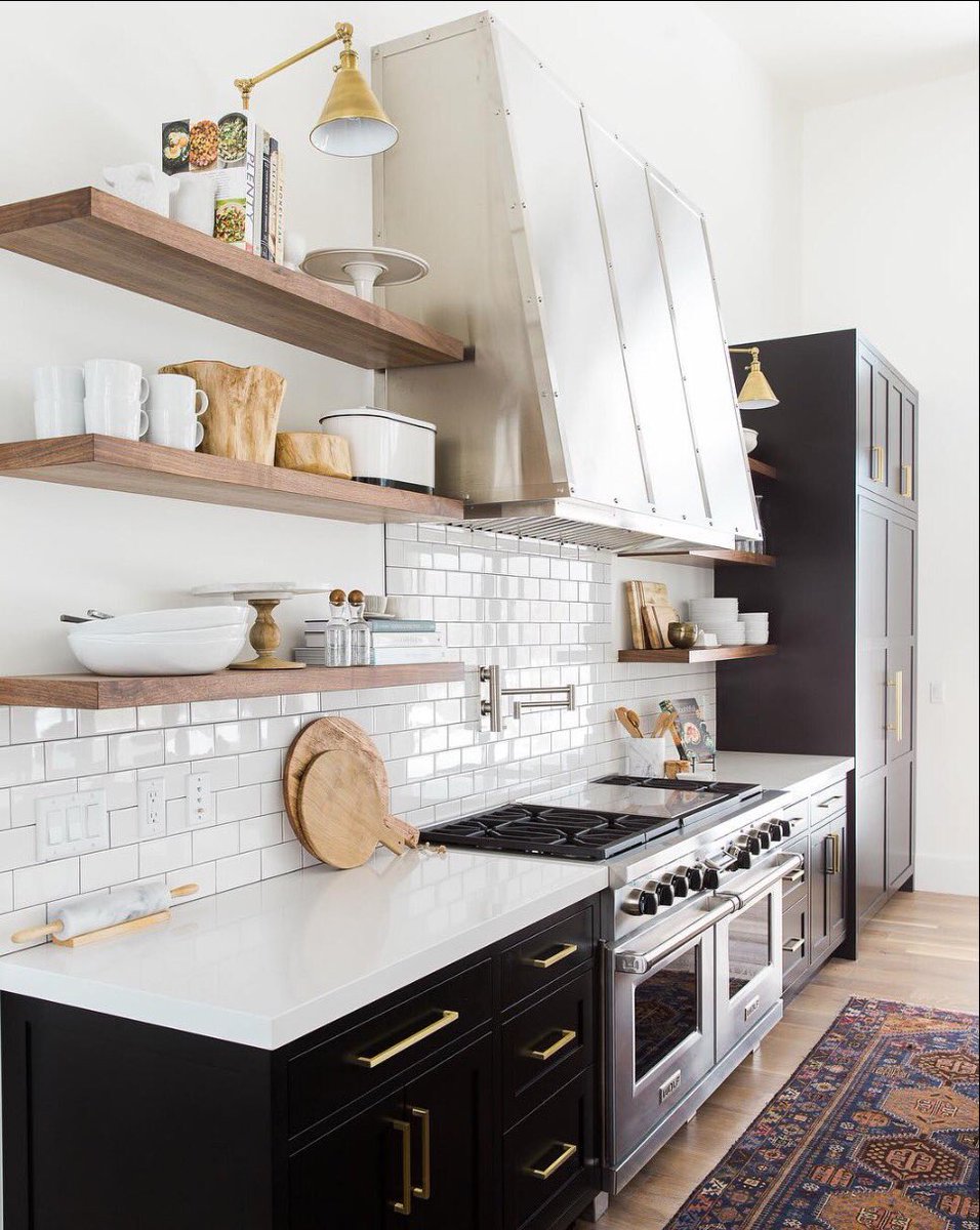 designwithidc's tweet image. Timeless and classics Stainless appliances, gold hardware and accents enhanced by glossy black cabinets topped with white quartz counters.