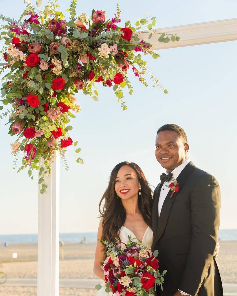 The vibrant red and green florals contrasted perfectly against the white sands and rentals. | Photo: @kathleengeiberger | Venue: @Shuttersc…