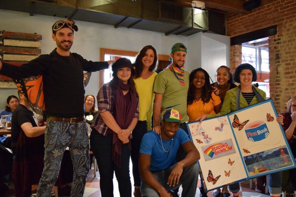 FirstBook's tweet photo. #TBT to that #Halloween when staff dressed up as "a @readingrainbow" - https://t.co/kv0qC6jFp3 #FirstBook25 https://t.co/4AqyW45CKW
